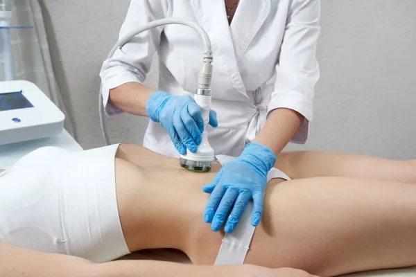 Lost the Weight but Not the Loose Skin? 2 woman having HIFU treatment on her stomach to combat loose skin Bexhill following weight loss